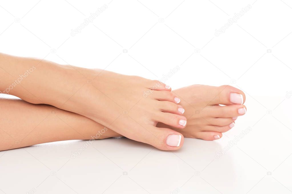 Tiny, female feet with delicate skin and perfectly done pedicure.