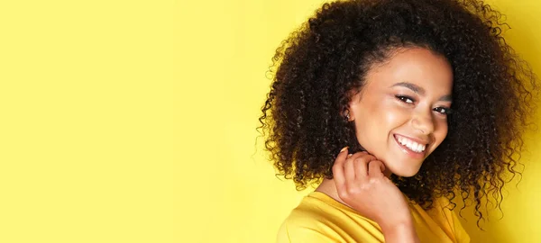 Super happy afro-american girl isolated on yellow background.