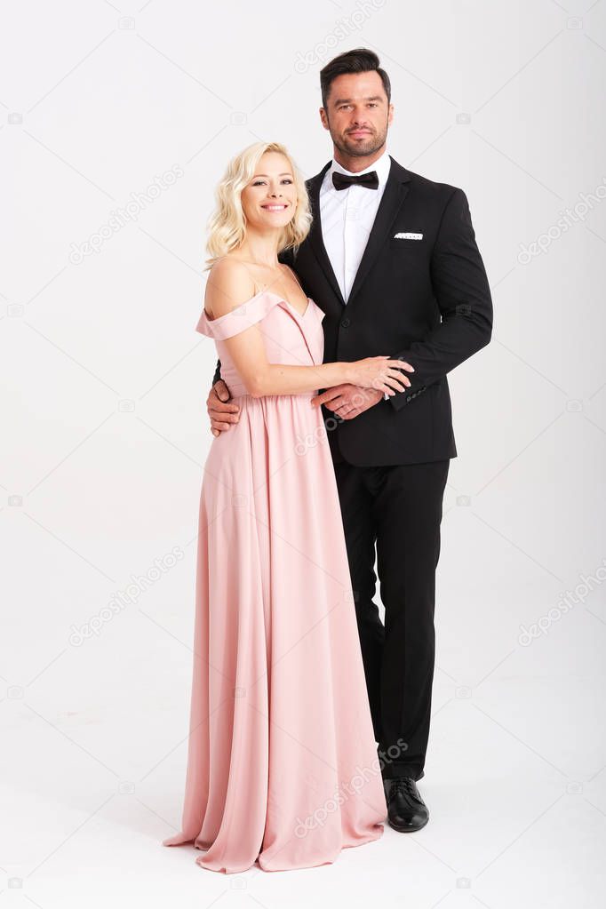 Beautiful couple of young people are dressing very elegant.