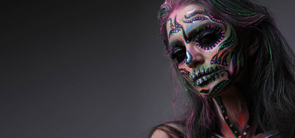 Model in terrifying make up isolated on grey background.