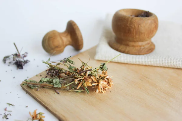 Ahşap tahta, tahta kaşık ve tahta bambu harcı üzerine Hypericum ve Kekik'ten yapılan bitki çayı