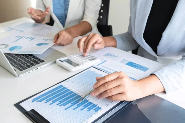 Two business leader women discussing the charts and graphs showing the results