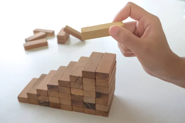 Image of hand holding blocks wood game to growing up of business, Risk of management and strategy plan — Stock Photo, Image