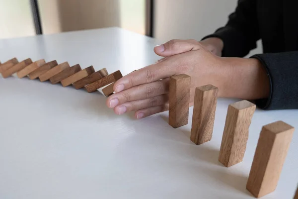 woman hand stop blocks wood game, gambling placing wooden block. Concept Risk of management and strategy plan, protect business to success