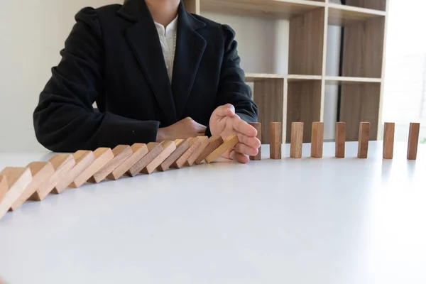 woman hand stop blocks wood game, gambling placing wooden block. Concept Risk of management and strategy plan, protect business to success