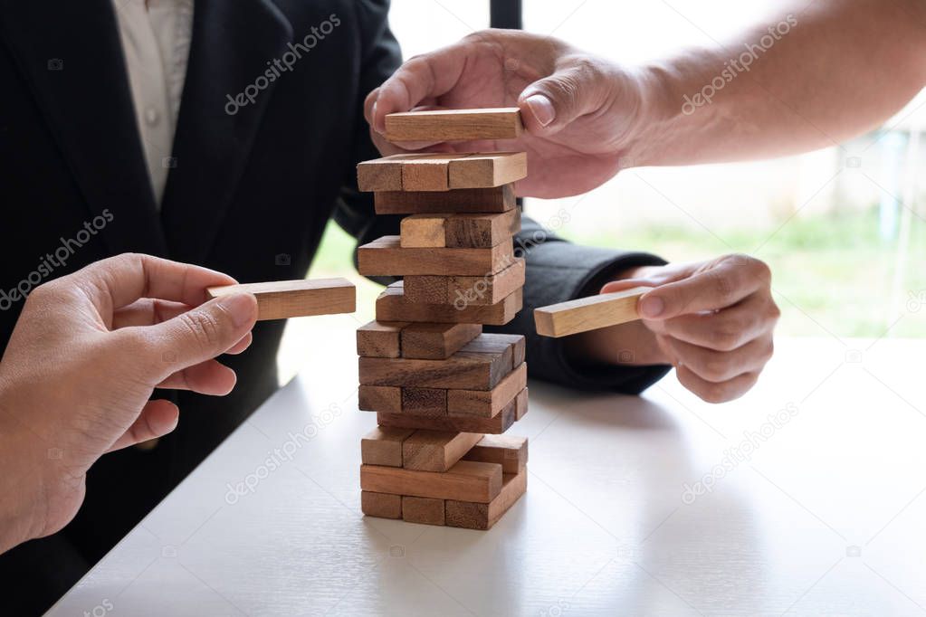 hands playing blocks wood game, gambling placing wooden block. Concept Risk of management and strategy plan, growth business success process and team work