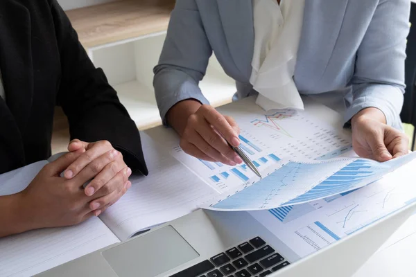 Two business leader women discussing the charts and graphs showing the results