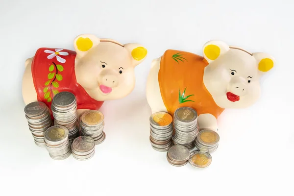 Red and Orange piggy bank saving money with coins pile