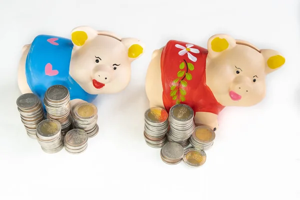 Blue and Red piggy bank saving money with coins pile