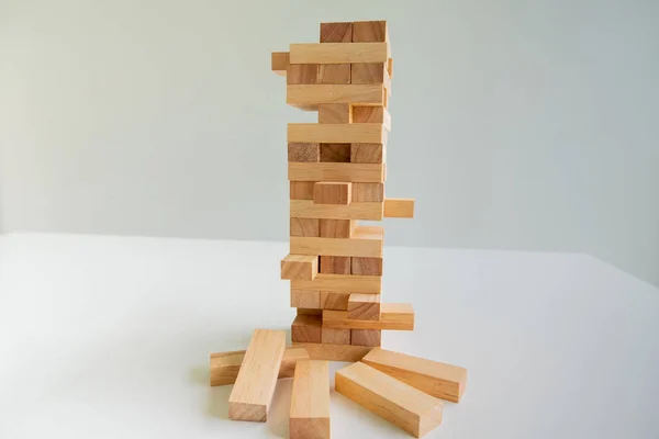 Wood block tower with architecture model, Concept Risk of management and strategy plan, growth business success process and team work