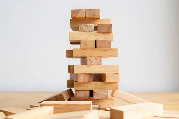 Wood block tower with architecture model, Concept Risk of management and strategy plan, growth business success process and team work.