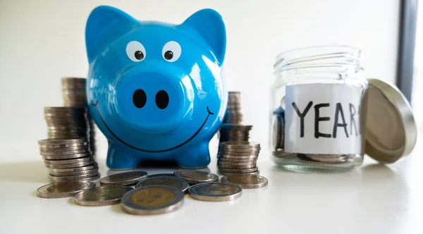 Blue piggy bank with coin pile, step up growing business to success and saving for retirement  concept