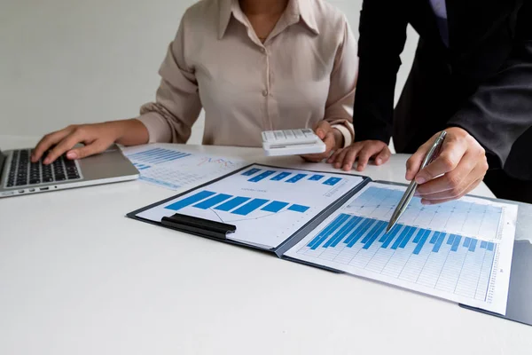 Two business leader women discussing the charts, graphs and showing the results for planning management new project