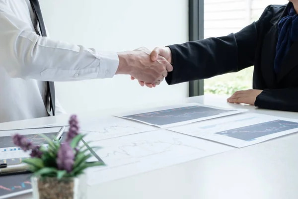 shaking hands, A team of business executives are planning consultations about business investments related to shares. By analyzing and calculating the stock market to find marketing profits.