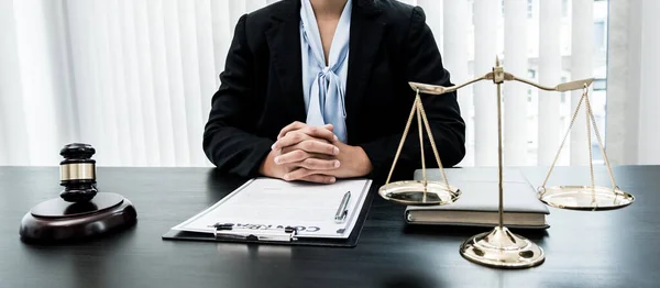 Professional women lawyers work at a law office There are scales, Scales of justice, judges gavel, and litigation documents. Concepts of law and justice.