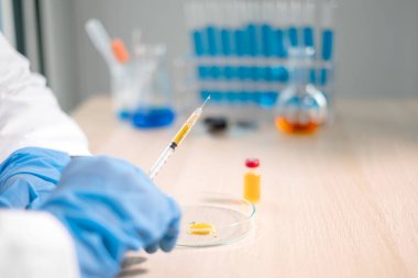 Profesyonel doktorlar aşı önleme ve viral enfeksiyonlardan korunmak için aşı örnekleri test edip analiz ederler. Tıbbi ve sağlık hizmetleri kavramları.