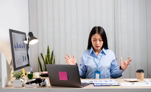 Working Asian women feel stressed, tired from work, migraine headaches from hard work while working at the office.