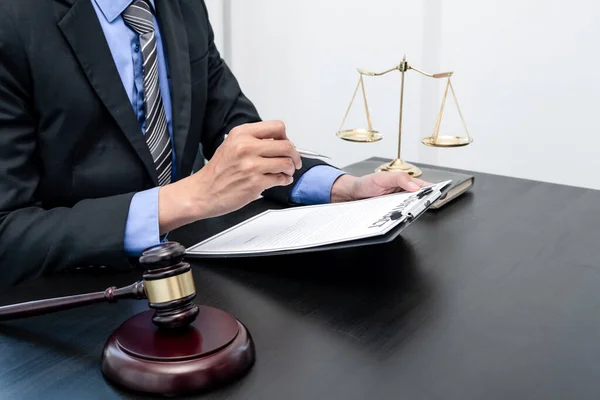 Professional male lawyers work at a law office There are scales, Scales of justice, judges gavel, and litigation documents. Concepts of law and justice.