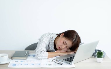 Asyalı kadınlar iş yerinde çalışırken laptoplarının üzerinde uyumaktan yorulurlar dinlenmek ve ofiste sıkı çalışırken dinlenmek için.