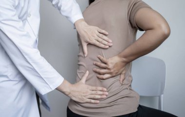 Kadın hastalar muayene ve tedavi için düşük bel ağrısı olan fizyoterapistlere danıştılar. Rehabilitasyon fizyoterapi konsepti.