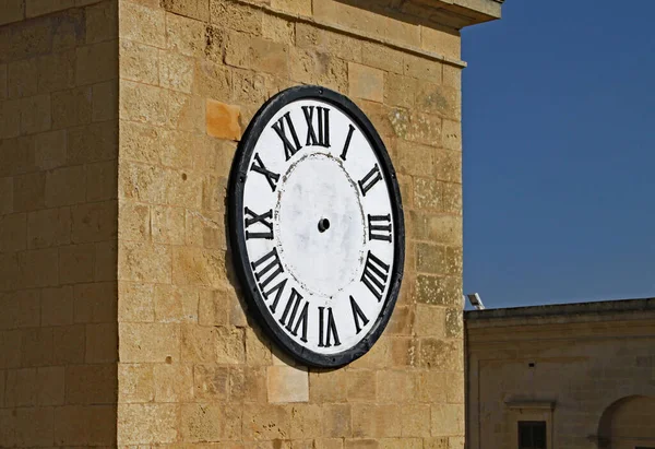 Clock with no hands on a tower in Malta