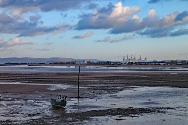 Boats in the harbour at Minehead in Somerset. The tide is out and the sky is stormy clipart