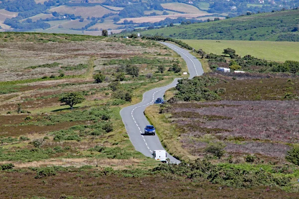 Country road cuts across Exmoor National park near Minehead in Somerset, England.