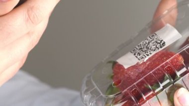 Çilekler üzerindeki QR kodu telefonla taranıyor 