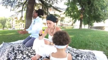 Güneşli bir günde parkta çok ırklı güzel bir aile.