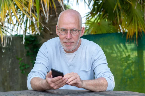 Ένας Ανώτερος Άνθρωπος Χρησιμοποιώντας Τηλέφωνο Στον Κήπο — Φωτογραφία Αρχείου