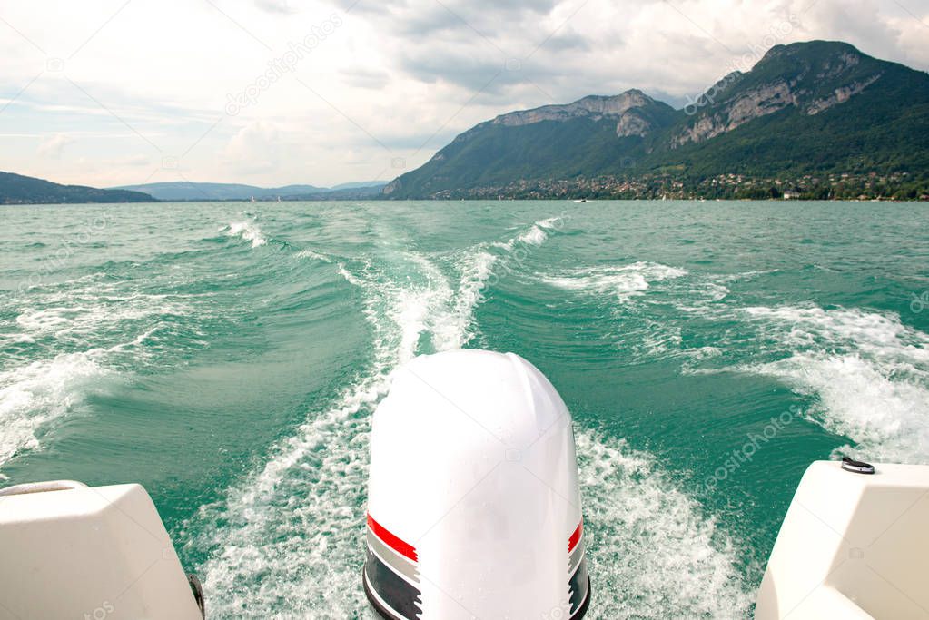 waves made by the engine of a boat on a Annecy lake