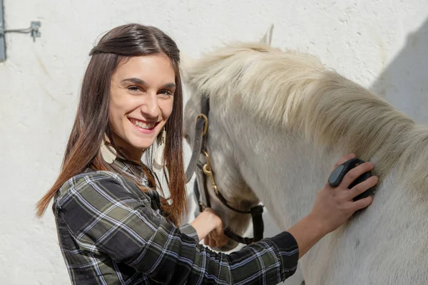 Young Woman Rider Brushing White Horse — Stock Photo, Image