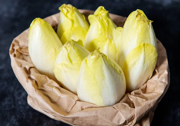 a paper bag with endives from France or Belgium