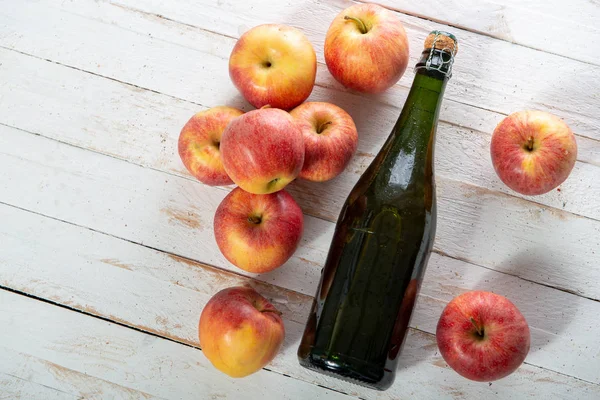 Bio Äpfel Mit Einer Flasche Cider Auf Einem Weißen Holztisch — Stockfoto