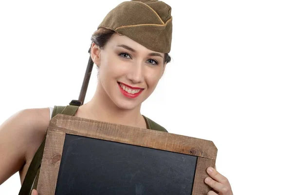 Young woman dressed in wwii military uniform with cap showing em — Stock Photo, Image