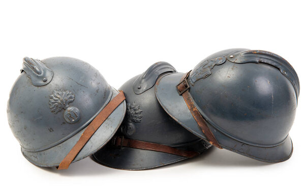 three french military helmets of the First World War on white ba