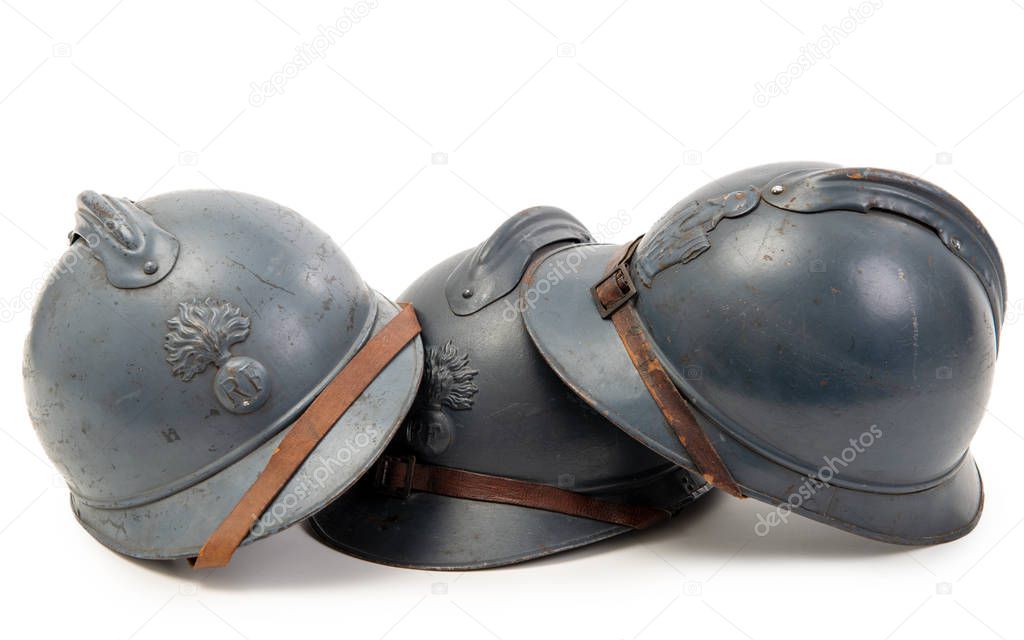 three french military helmets of the First World War on white ba
