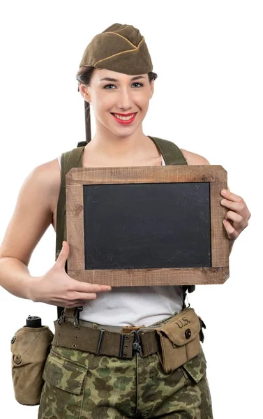 Young woman dressed in US ww2 military uniform with cap showing — Stock Photo, Image