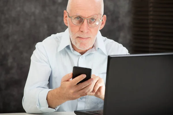 Hombre de negocios senior leyendo mensaje a teléfono inteligente —  Fotos de Stock