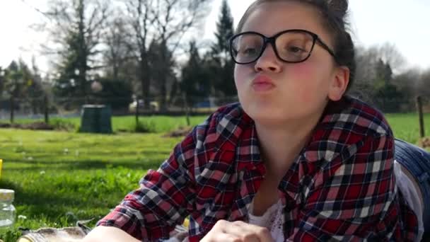 Teenage Girl Lying Grass Doing Homework Eating Cake — Stock Video