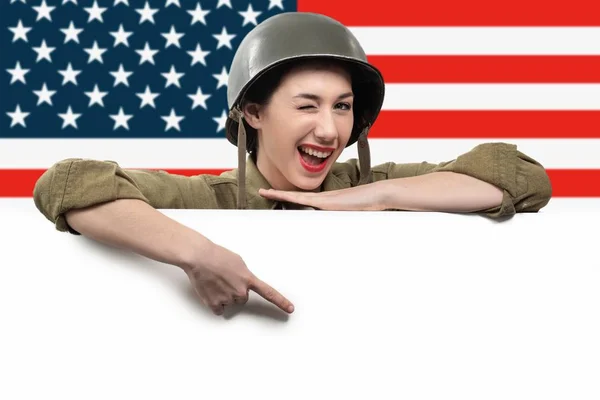 Young woman dressed in American ww2 military uniform showing emp — Stock Photo, Image