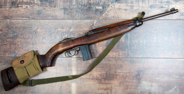 Vintage military m1 carbine rifle, with a two clip pouch on the 