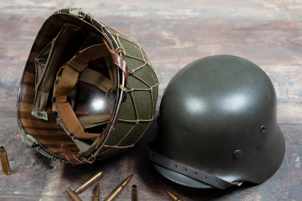 German and U.S  World War Two military helmets, battle of Norman