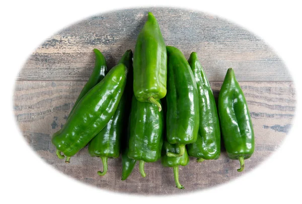 Green peppers on the wooden table isolated on the white backgrou — Stock Photo, Image