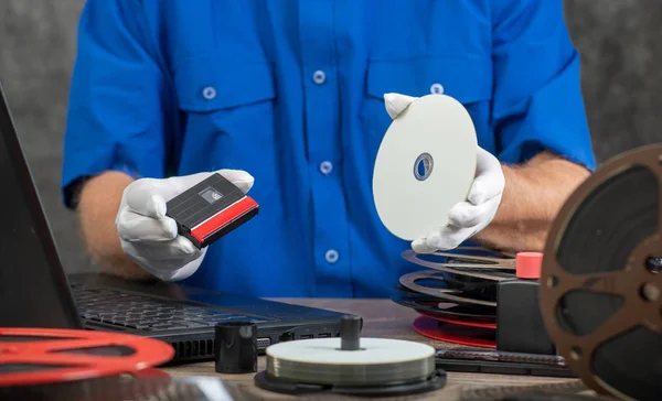 Technician with white gloves digitizing mini-DV cassette — Stock Photo, Image