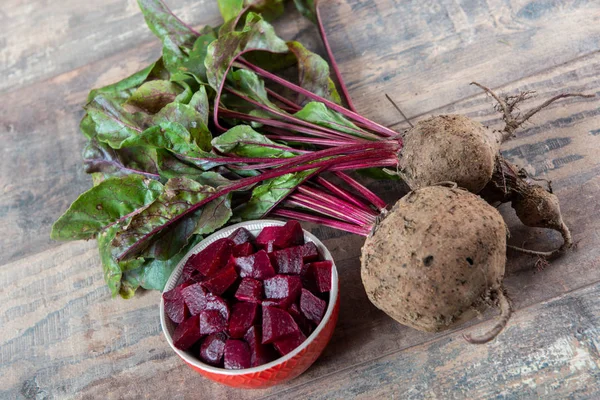 Organic beetroots with salad on wooden background — Stock Photo, Image