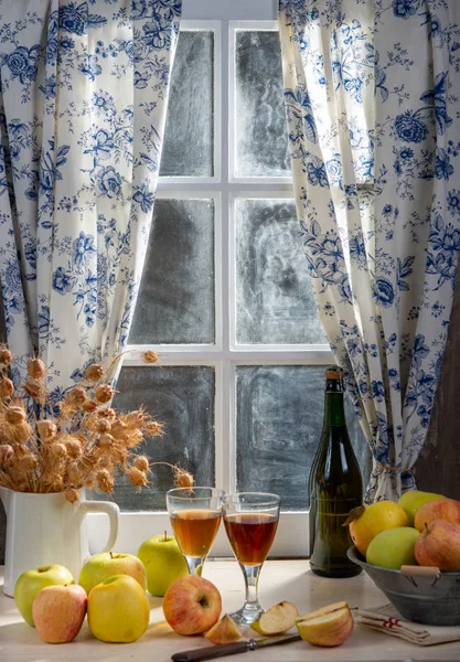 Bottle and glasses of cider with apples. In rustic house, window — Stock Photo, Image