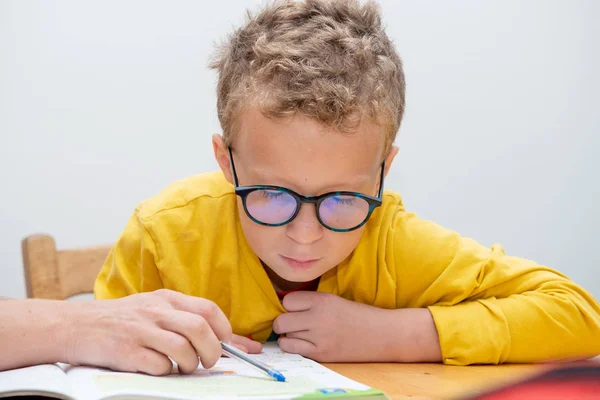 Mały chłopiec odrabia lekcje. — Zdjęcie stockowe