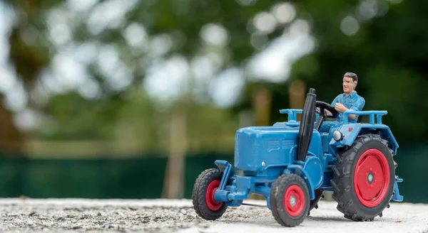 a blue tractor toy model