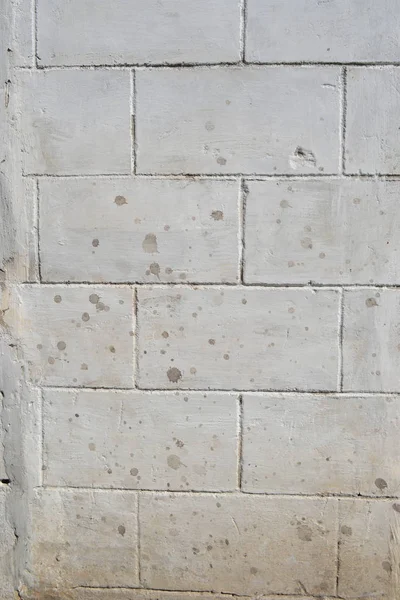 Plastered wall,painted with fake large bricks,background